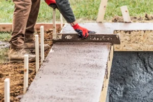 construction worker leveling wet cement